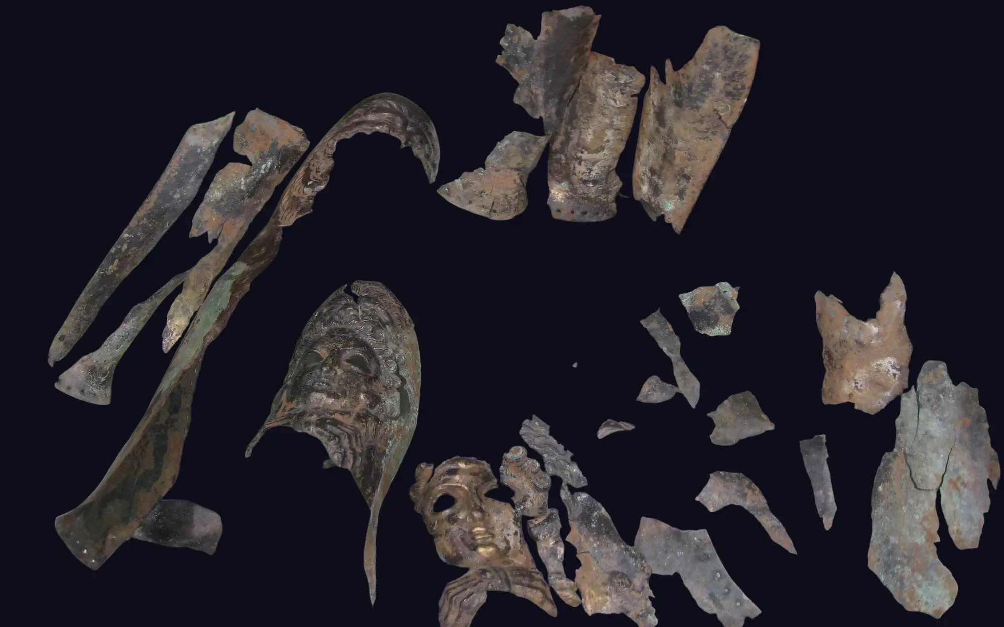 Fragments of a decorative bronze mask before restoration